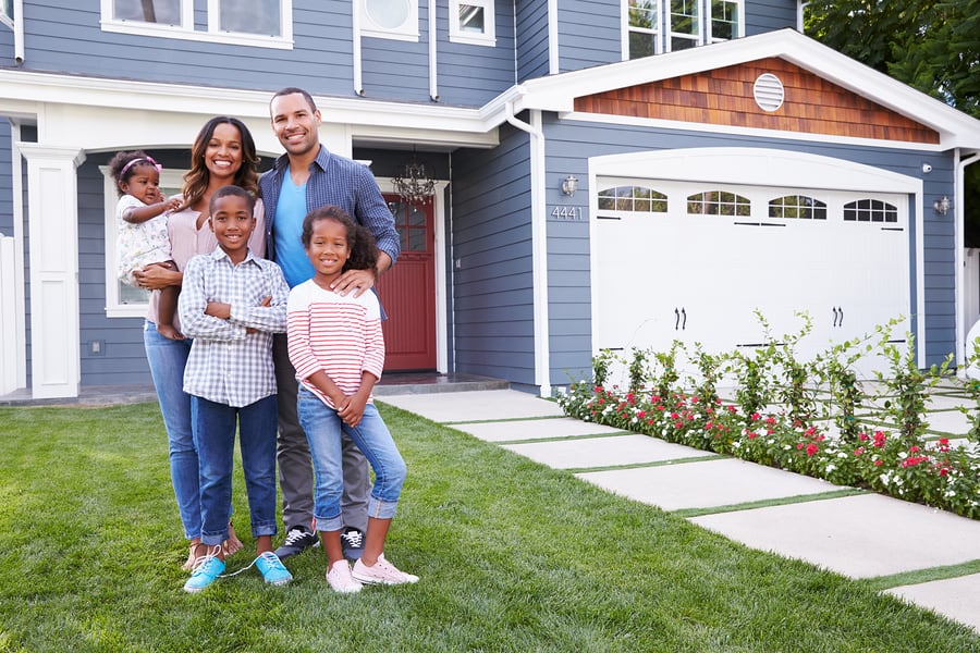 Family Standing in front of home